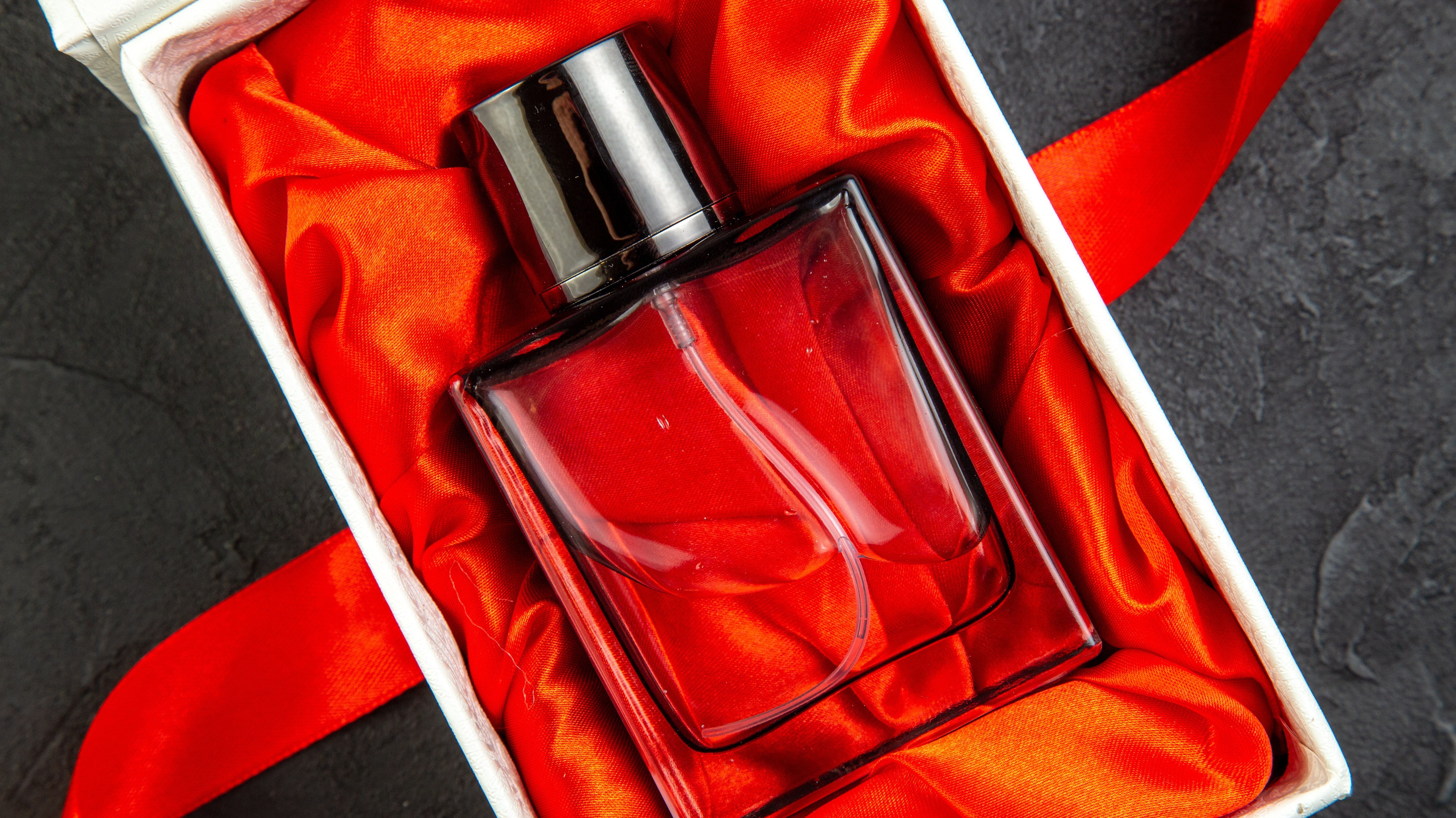 Elegantly packaged clear perfume bottle.