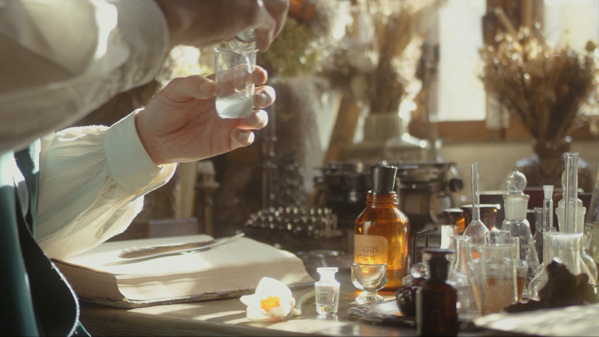 Perfumer blending raw fragrance materials during the perfume creation process.