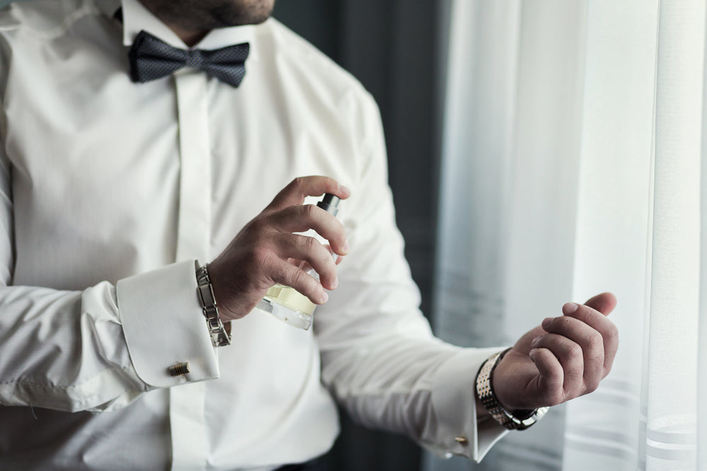 Man Spraying Perfume